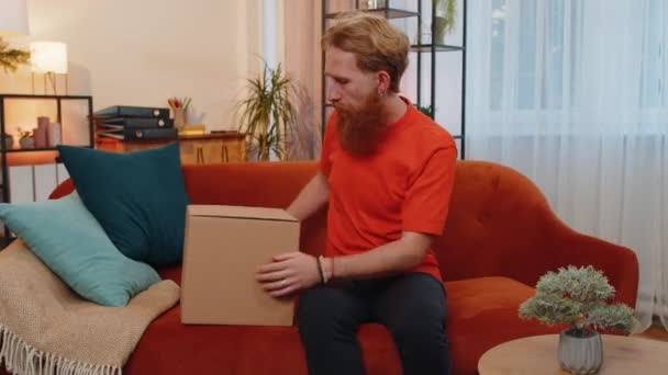 Happy Surprised Winner Adult Man Unpacking Delivery Parcel Home Smiling — Vídeo de Stock