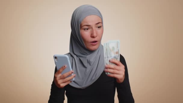 Happy Muslim Woman Hijab Looking Smartphone Display Sincerely Rejoicing Win — Stock Video