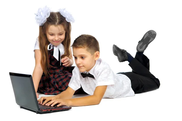 A boy, a girl and a laptop — Stock Photo, Image