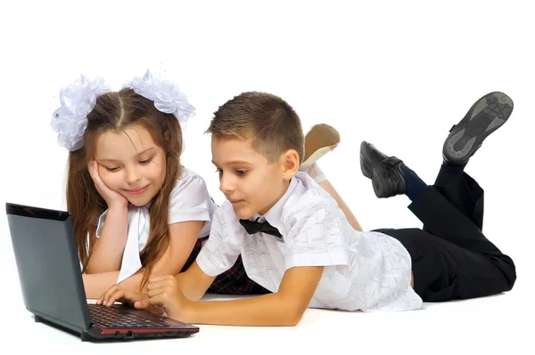 A boy, a girl and a laptop — Stock Photo, Image