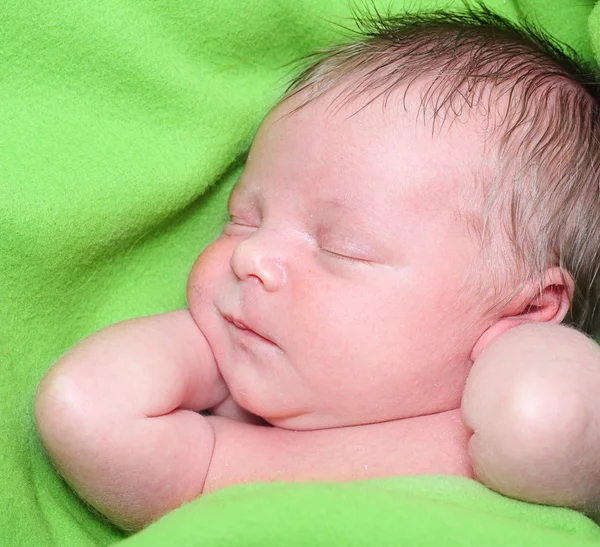 Sleeping Newborn Baby Boy in a Green Blanket