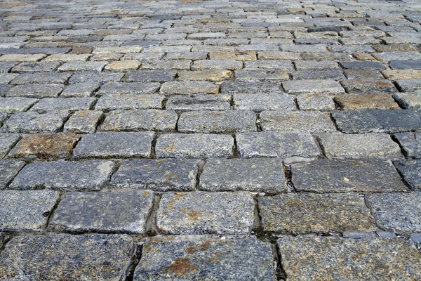 Spotted cobblestone background in perspective — Stock Photo, Image