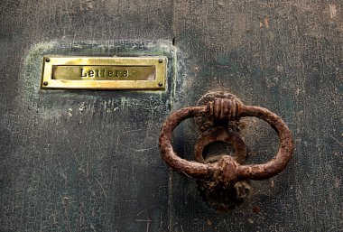 Very Old door handle and place for letters with old texture background clipart