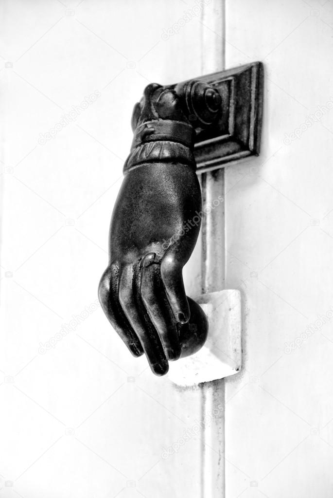 Old Hand Doorknocker on a door in black and white photo, B&W photo, Old rusty gate latch on the door, Door Knocker, Ancient Knocker, Door knob black and white,interior detail close up, exterior detail