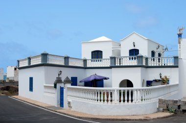 Typical spanish villa near the sea, white house in small village in Lanzarote, typical white house in Lanzarote. Lanzarote, Spain. Apartments view. Nice white building in spanish village clipart