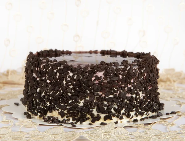 Chocolate Cake with Chocolate, Cake isolated on warm light background with selective focus and uneven light. Concept. Birthday cake in blur decorated background — Stock Photo, Image