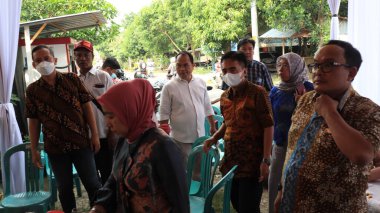 Guests enjoying a traditional wedding party, Kendal, Indonesia, 6 July, 2022