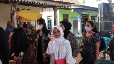 Guests enjoying a traditional wedding party, Kendal, Indonesia, 6 July, 2022