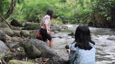 Tourists playing in the water in a beautiful river on a sunny summer day