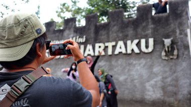 Tourists are looking at Museum Mini Sisa Hartaku (My Remaining Treasure Mini Museum), Yogyakarta, Indonesia July 20, 2022