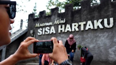 Tourists are looking at Museum Mini Sisa Hartaku (My Remaining Treasure Mini Museum), Yogyakarta, Indonesia July 20, 2022