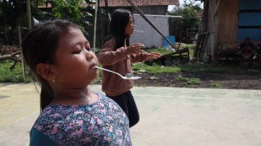 portrait of indonesian spoon marbles race during independence day, Batang Indonesia, August 17 2022