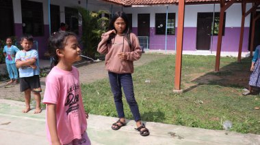 portrait of indonesian spoon marbles race during independence day, Batang Indonesia, August 17 2022