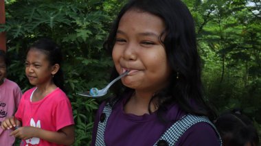 portrait of indonesian spoon marbles race during independence day, Batang Indonesia, August 17 2022