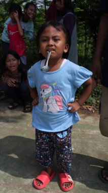 portrait of indonesian spoon marbles race during independence day, Batang Indonesia, August 17 2022