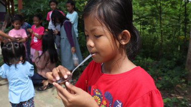 portrait of indonesian spoon marbles race during independence day, Batang Indonesia, August 17 2022