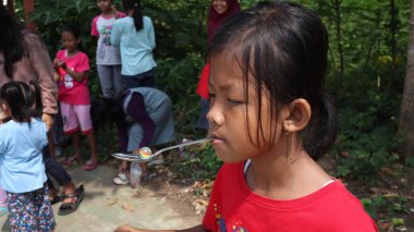 portrait of indonesian spoon marbles race during independence day, Batang Indonesia, August 17 2022