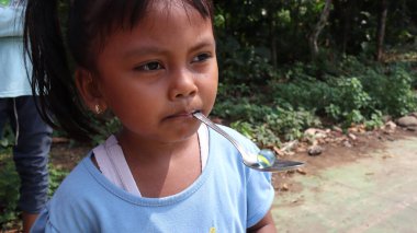 portrait of indonesian spoon marbles race during independence day, Batang Indonesia, August 17 2022