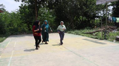 portrait of indonesian spoon marbles race during independence day, Batang Indonesia, August 17 2022
