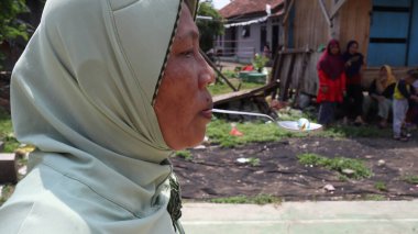 portrait of indonesian spoon marbles race during independence day, Batang Indonesia, August 17 2022