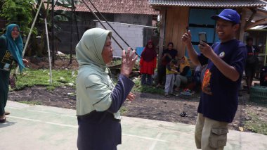 portrait of indonesian spoon marbles race during independence day, Batang Indonesia, August 17 2022