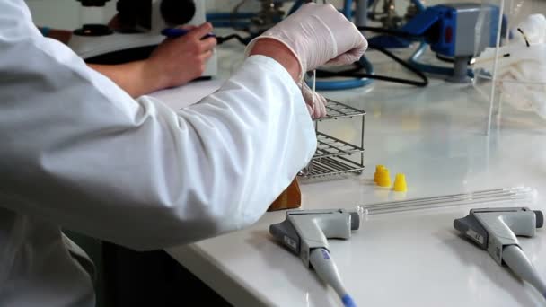 Shot of the young pharmacist during the experiment — Stock Video