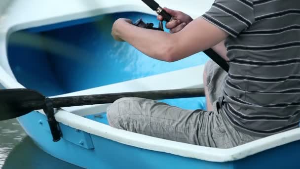 Young man fishing on a boat — Stock Video