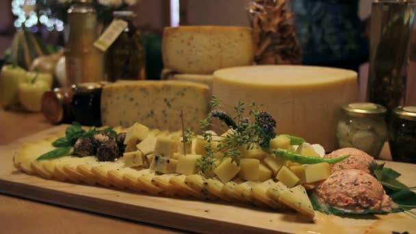 Man's hand picking served cheese from board — Stock Video