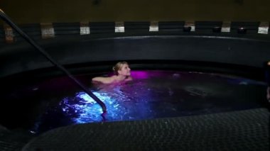 Couple in colorful jacuzzi