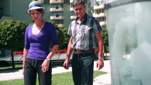 Shot of a young beautiful couple when walking towards special tunel with mineral water — Stock Video