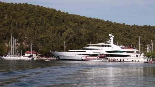 Shot of the big yacht docked near Split taken from the moving boat — Stock Video