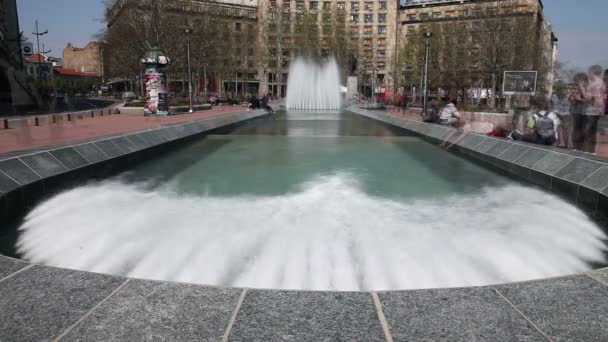 Prise de vue d'une fontaine à Belgrade avec des gens marchant autour ressemblant à des fantômes — Video