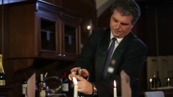 Close up shot of a waiter who is opening a bottle of old, special wine — Stock Video