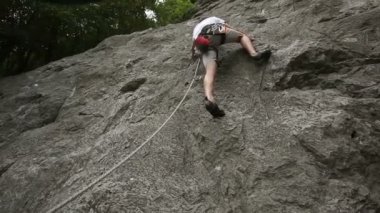genç adam kaya doğada büyük bir kayaya tırmanma