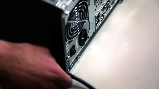 Shot of a hand plugging in a PC — Stock Video