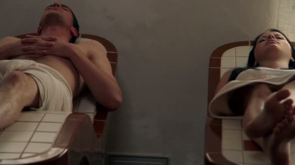 People relaxing in sauna — Wideo stockowe