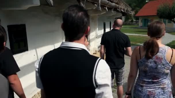 Shot of a group of young people visiting an old but very preserved farm — Stock Video