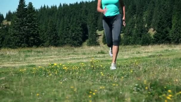 Woman tying up shoelaces while jogging — Stock Video