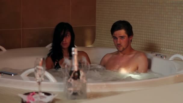 Pareja joven enamorada en jacuzzi — Vídeo de stock