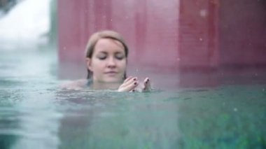 Ne zaman kar yağışı mavi bikinili genç ve güzel bir kadın bu enoys Açık Yüzme havuzunda vurdu