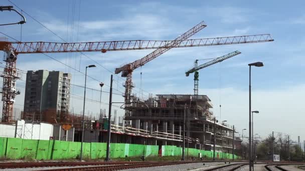 Cranes working on construction site. Time lapse is included. — Stock Video
