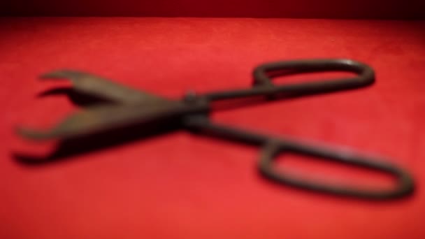 Close up shot of an old scissors on the red basis — Stock Video