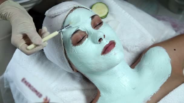 Woman taking facial mask — Stock Video