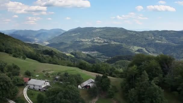 Panorama slide shot from helicopter representing valley with fields, meadows, forest and few houses — Stock Video