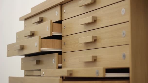 Close up shot of several narrow drawers, some are opened and some are closed — Stock Video