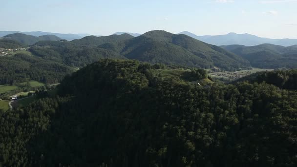 Panorama slide shot de helicóptero representando colinas cobertas com floresta verde — Vídeo de Stock