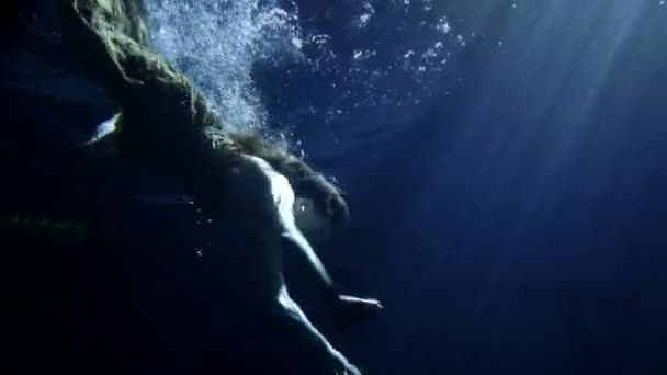 Woman swimming under water in long yellow dress — Stock Video