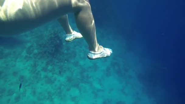 Woman legs with protective shoes underwater sea — Stock Video