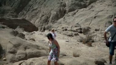 Üç turistler safari kayalık arazide yukarı gidiş