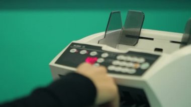 Bankacı otomatik sayaç ile parayı sayıyor